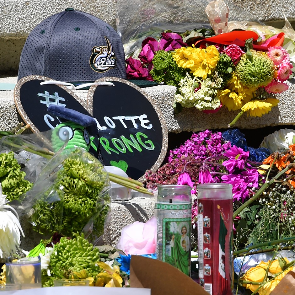 Flowers and a handmade paper heart reading "Charlotte Strong"