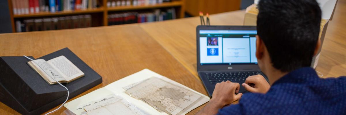 Over-the-shoulder image of student using archives and rare books in the reading room