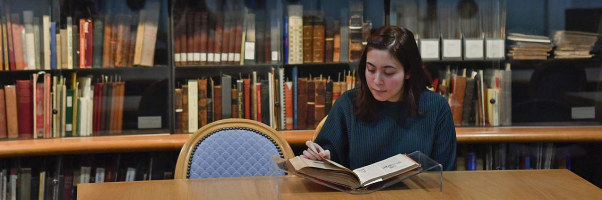 Student reading a rare book