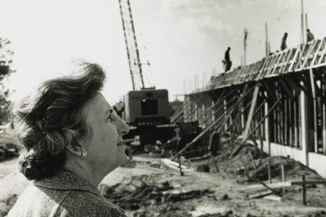 Bonnie Cone looking at the Library Building under construction in 1963.