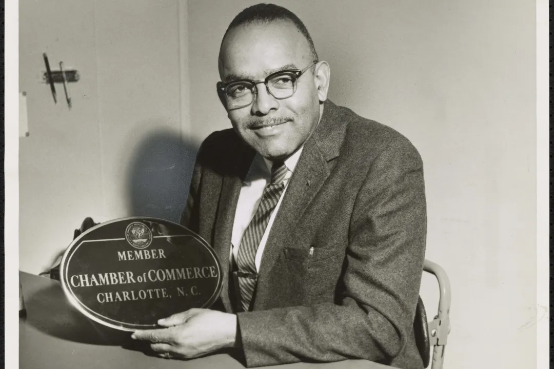Fred Alexander holding an award from the Chamber of Commerce