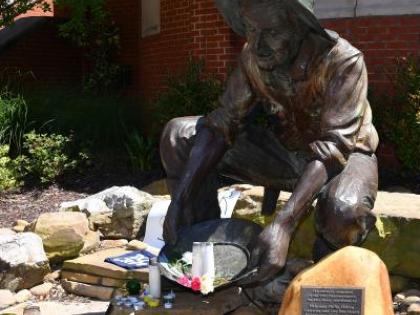 49er Miner statue with April 30 memorial items